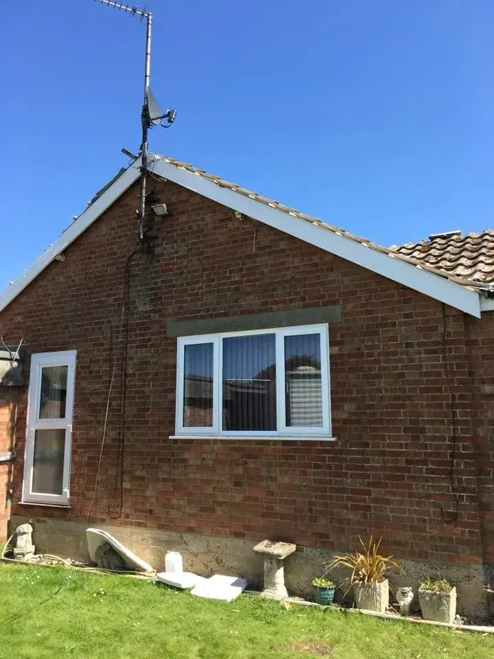New black gutter and white uPVC soffit along a house eaves in Norwich