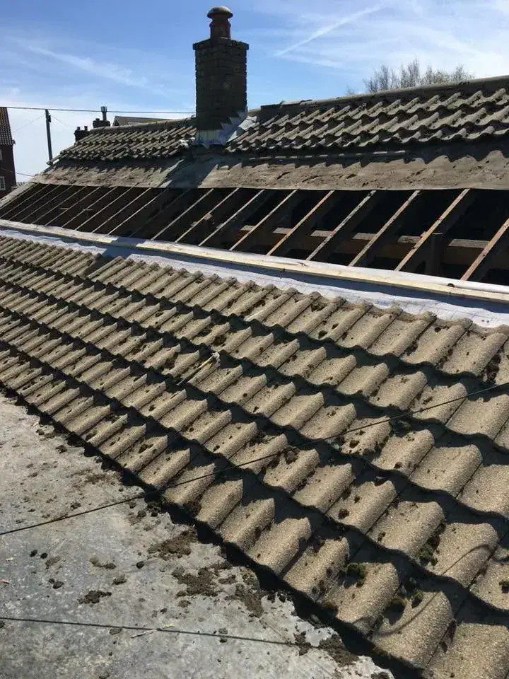 Pitched roof stripped back to the battens during a re-roof in Norwich