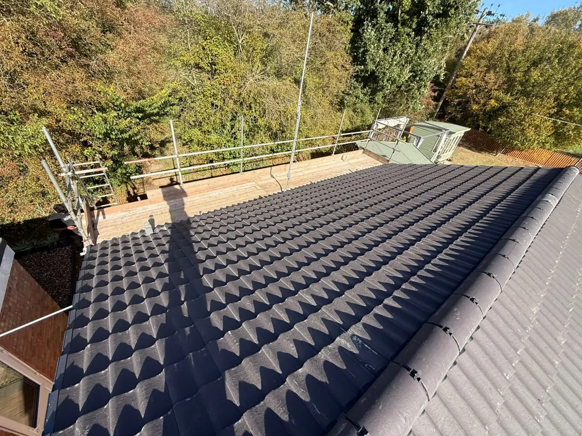 Finished grey concrete tile roof on a bungalow in Diss with scaffold edge protection