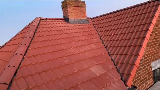 New red pantile roof with the chimney stack leadwork dressed in