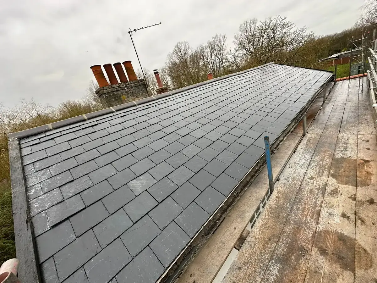 Completed natural slate roof on a house in Norfolk seen along the elevation