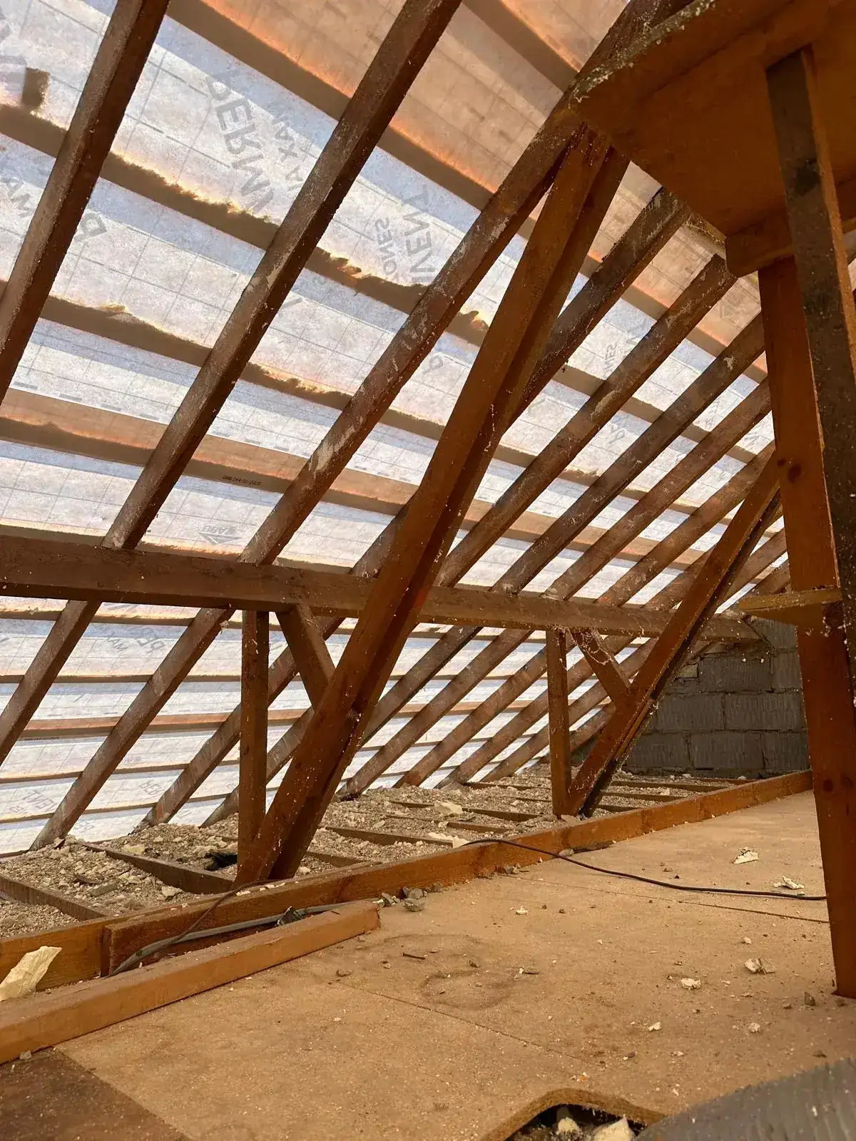 Wide view of a stripped loft with new breathable membrane above the rafters