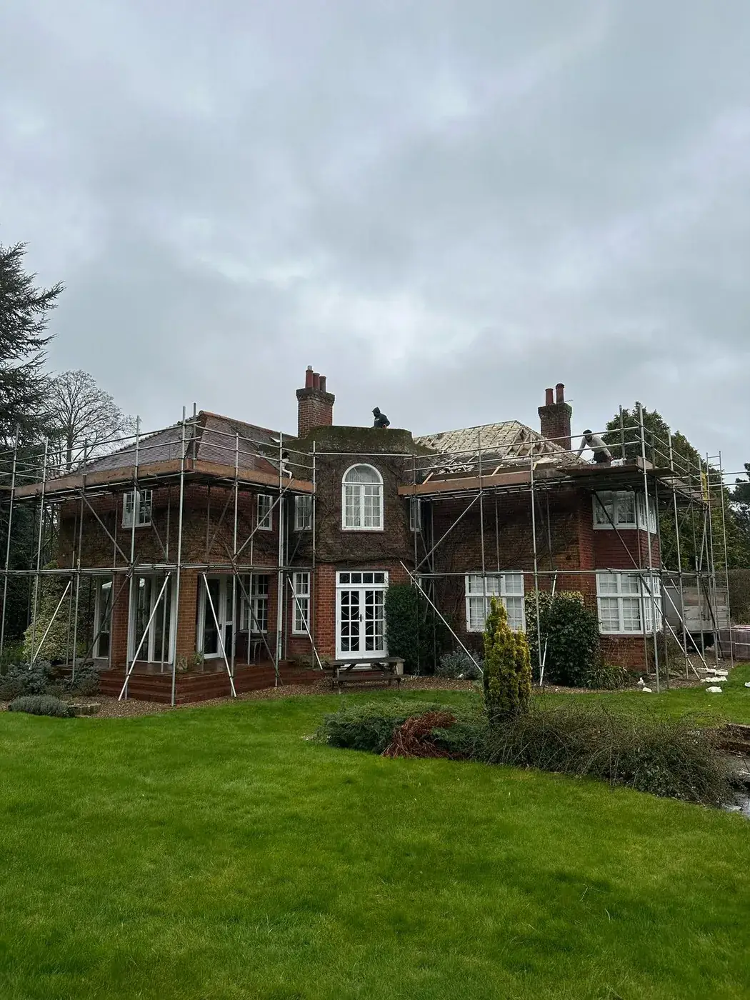 Scaffolded period house part way through the spray foam strip out
