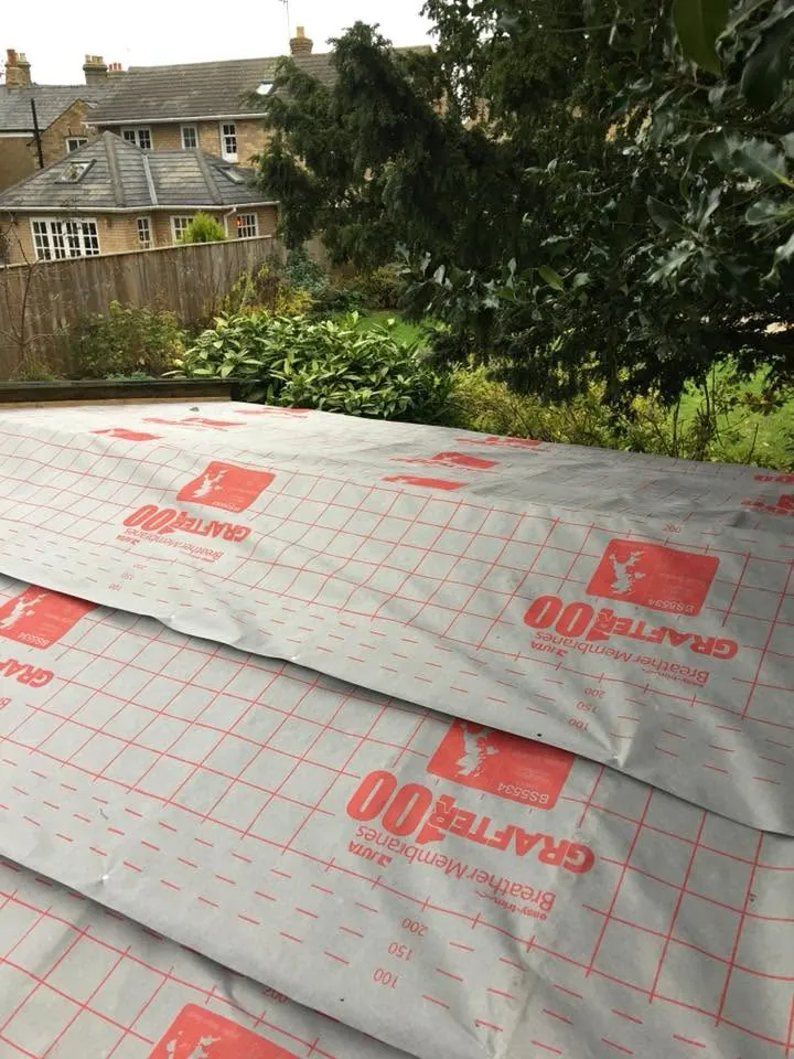 Breathable roofing membrane lapped across a workshop roof deck